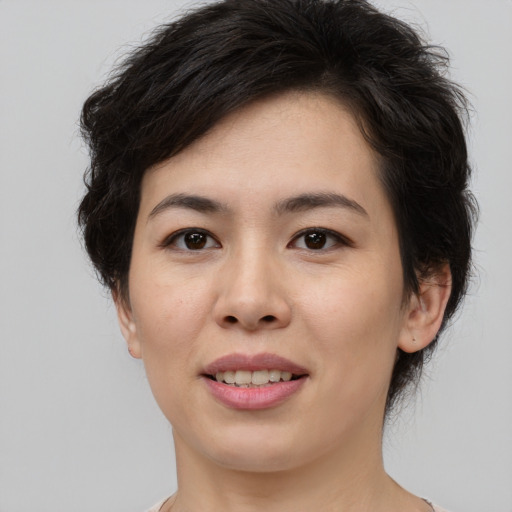 Joyful asian young-adult female with medium  brown hair and brown eyes