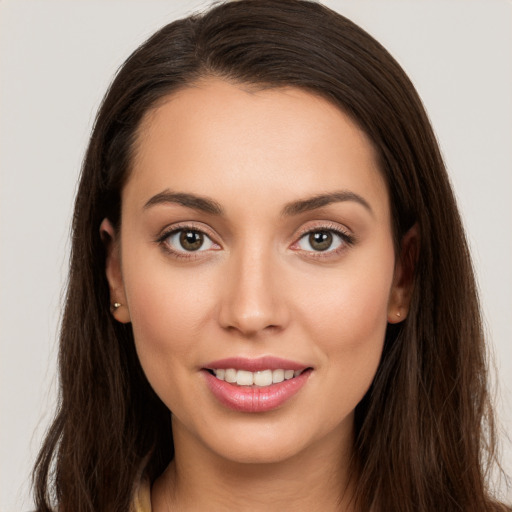 Joyful white young-adult female with long  brown hair and brown eyes