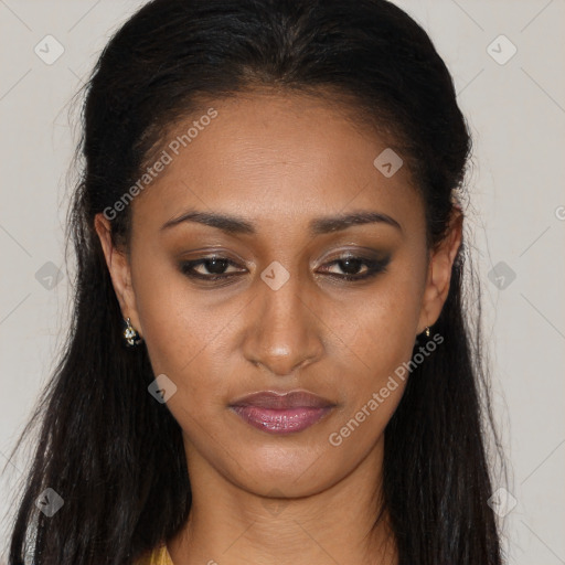 Joyful black young-adult female with long  brown hair and brown eyes