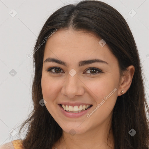 Joyful white young-adult female with long  brown hair and brown eyes