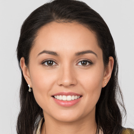 Joyful white young-adult female with long  brown hair and brown eyes