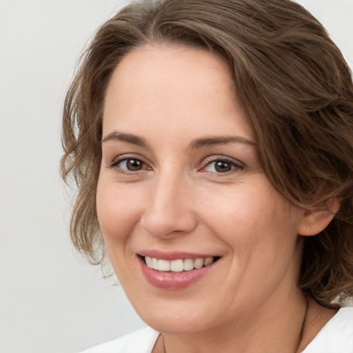 Joyful white young-adult female with medium  brown hair and green eyes