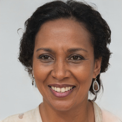 Joyful latino adult female with short  brown hair and brown eyes