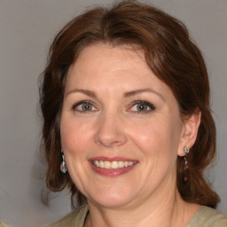 Joyful white adult female with medium  brown hair and brown eyes