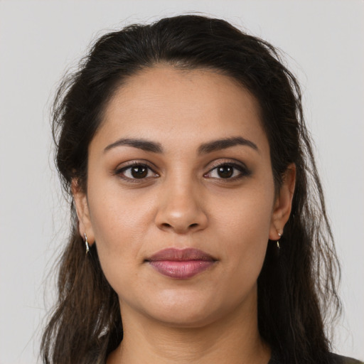 Joyful latino young-adult female with long  brown hair and brown eyes