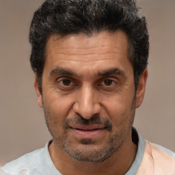 Joyful white adult male with short  black hair and brown eyes