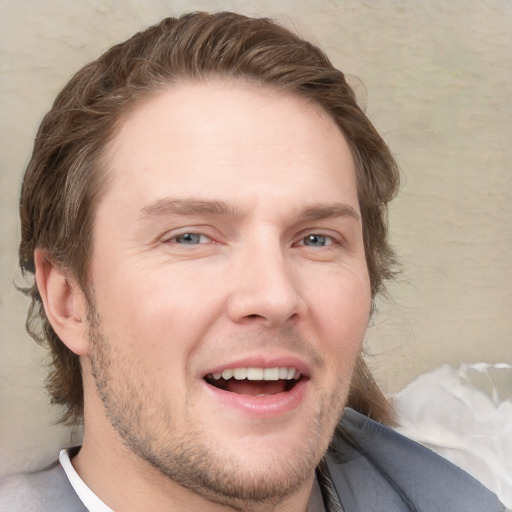 Joyful white young-adult male with short  brown hair and grey eyes