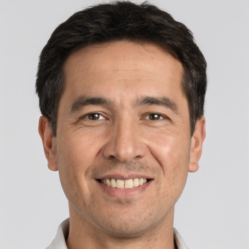 Joyful white adult male with short  black hair and brown eyes