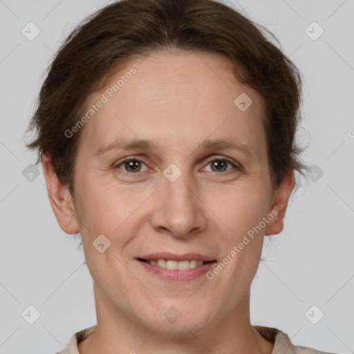 Joyful white adult female with short  brown hair and grey eyes