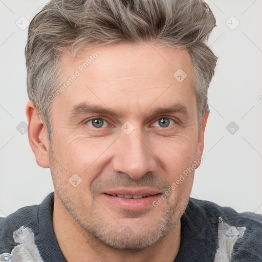 Joyful white adult male with short  brown hair and grey eyes