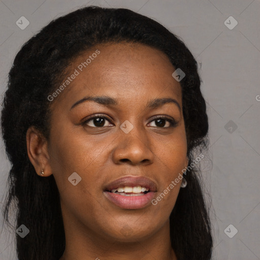 Joyful black young-adult female with long  brown hair and brown eyes