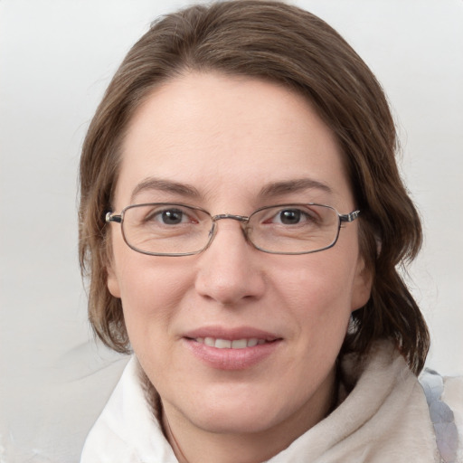 Joyful white adult female with medium  brown hair and blue eyes