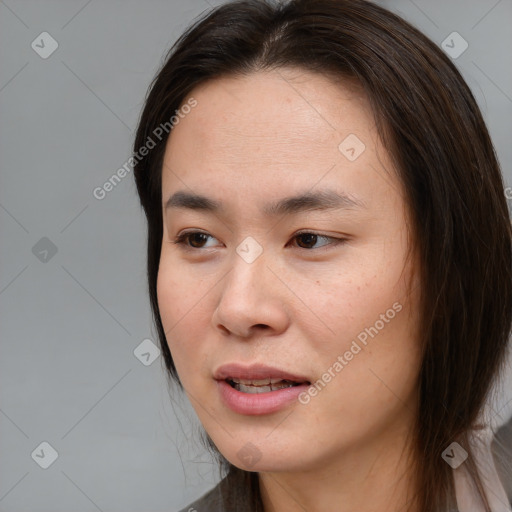 Joyful asian young-adult female with medium  brown hair and brown eyes