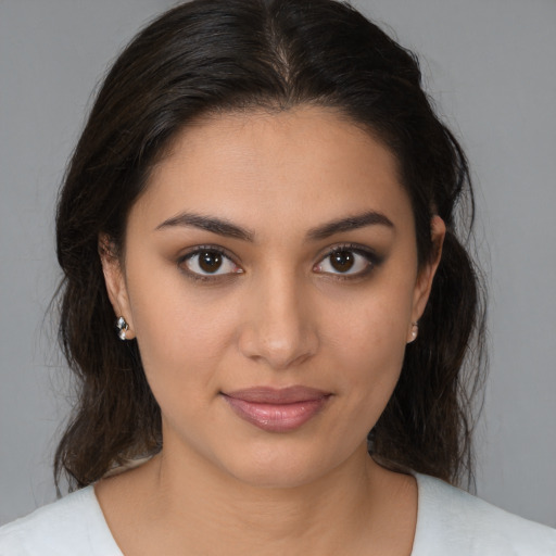 Joyful latino young-adult female with medium  brown hair and brown eyes