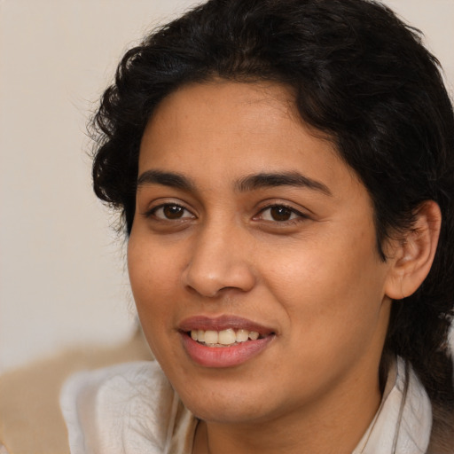 Joyful latino young-adult female with medium  brown hair and brown eyes
