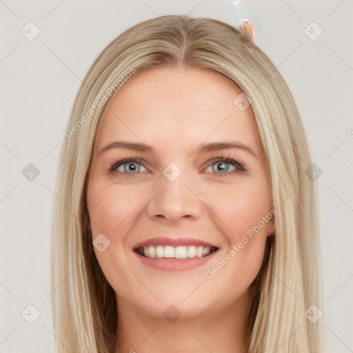 Joyful white young-adult female with long  blond hair and blue eyes