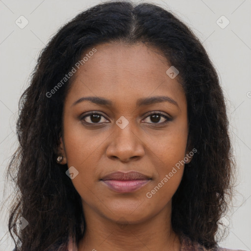 Joyful black young-adult female with long  brown hair and brown eyes