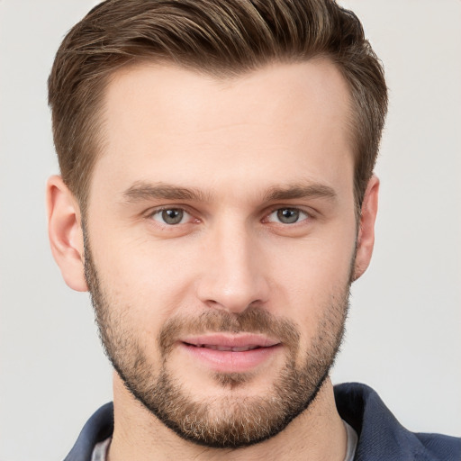 Joyful white young-adult male with short  brown hair and grey eyes