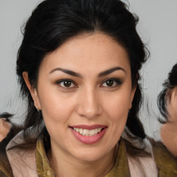 Joyful latino young-adult female with medium  brown hair and brown eyes