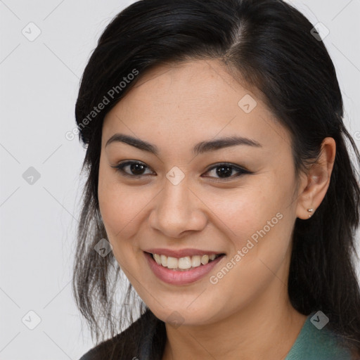 Joyful latino young-adult female with long  brown hair and brown eyes