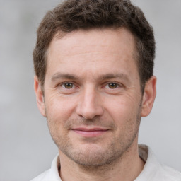 Joyful white adult male with short  brown hair and brown eyes