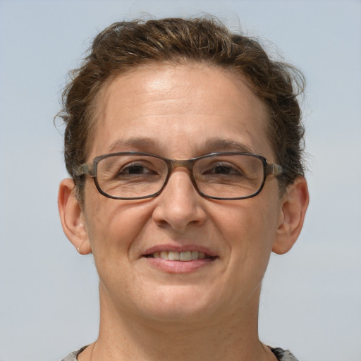 Joyful white adult female with short  brown hair and grey eyes