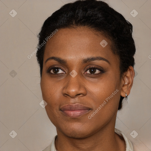 Joyful black young-adult female with short  brown hair and brown eyes