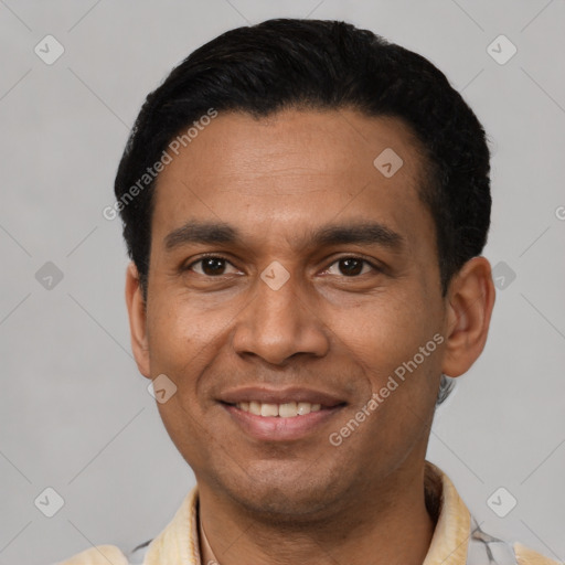 Joyful latino young-adult male with short  black hair and brown eyes
