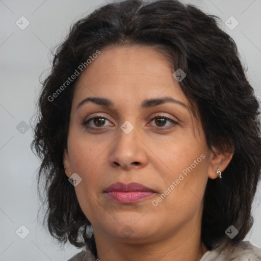 Joyful latino adult female with medium  brown hair and brown eyes