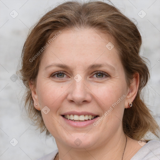 Joyful white adult female with medium  brown hair and grey eyes