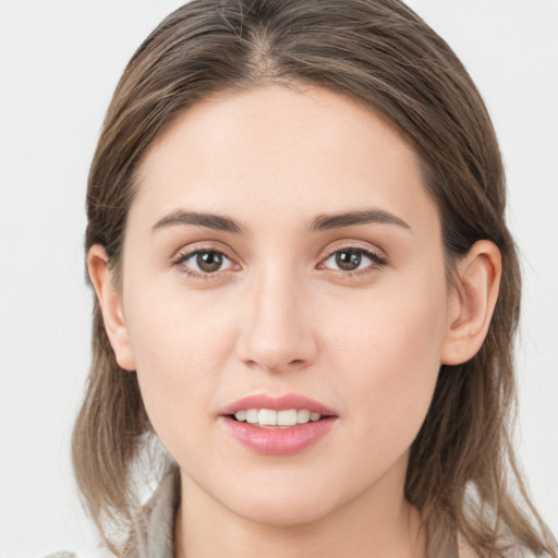 Joyful white young-adult female with medium  brown hair and grey eyes