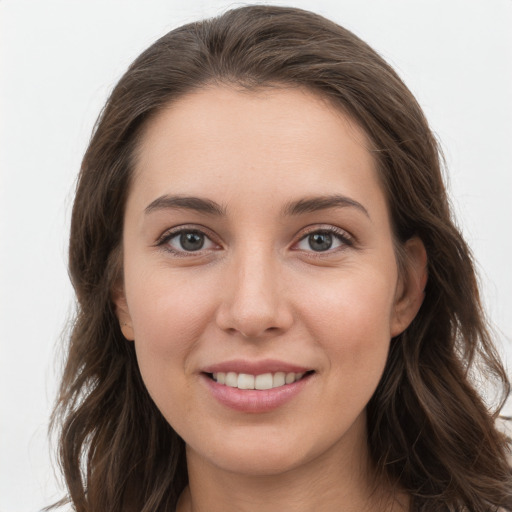 Joyful white young-adult female with long  brown hair and grey eyes