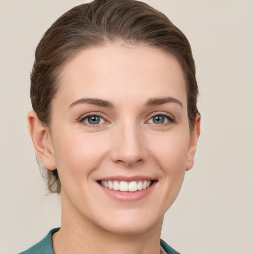 Joyful white young-adult female with short  brown hair and grey eyes