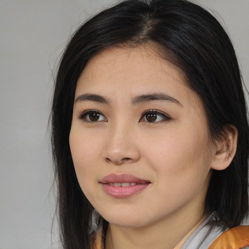 Joyful asian young-adult female with medium  black hair and brown eyes