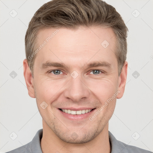 Joyful white adult male with short  brown hair and grey eyes