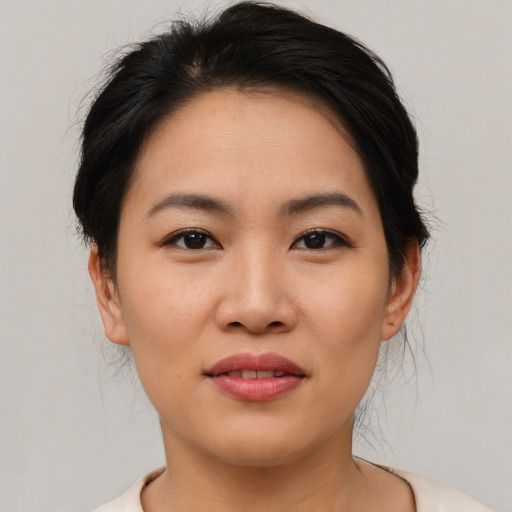 Joyful asian young-adult female with medium  black hair and brown eyes