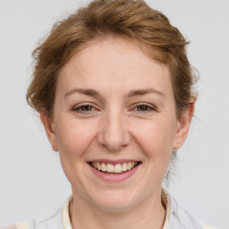 Joyful white adult female with medium  brown hair and grey eyes