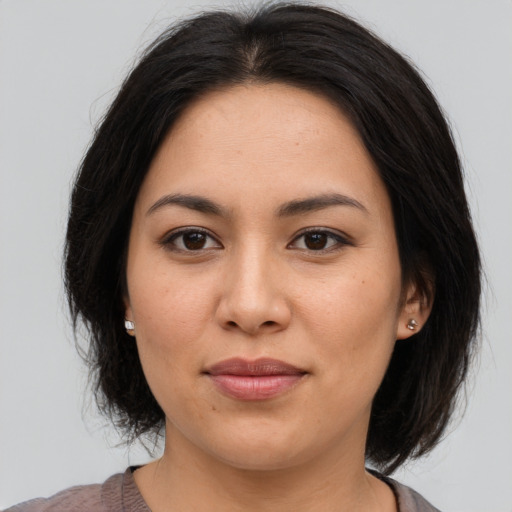 Joyful asian young-adult female with medium  brown hair and brown eyes