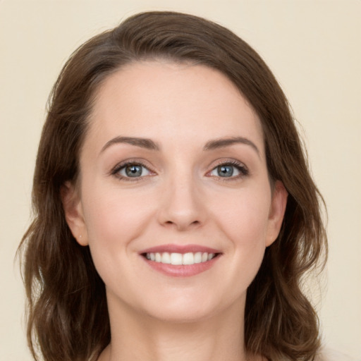 Joyful white young-adult female with long  brown hair and green eyes