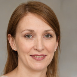 Joyful white adult female with medium  brown hair and grey eyes