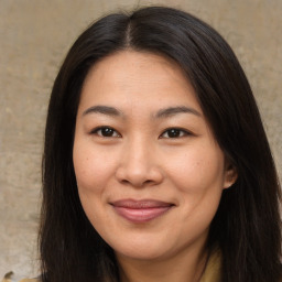 Joyful asian young-adult female with medium  brown hair and brown eyes