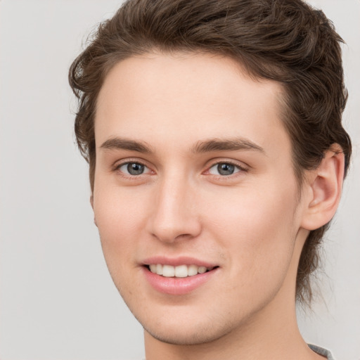 Joyful white young-adult female with short  brown hair and grey eyes