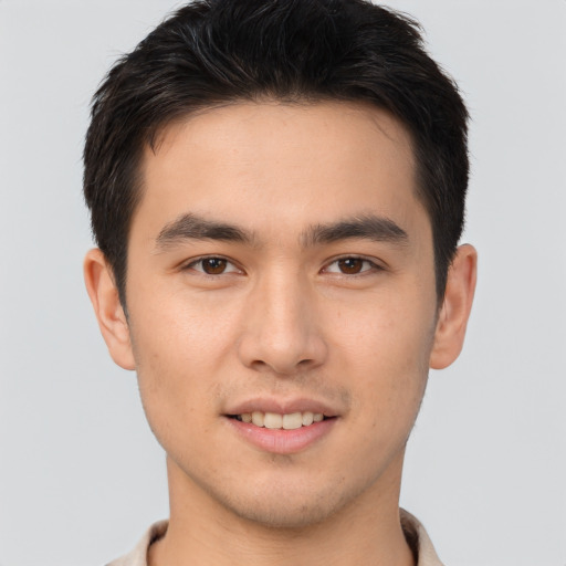 Joyful asian young-adult male with short  brown hair and brown eyes