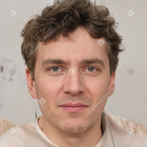 Joyful white adult male with short  brown hair and grey eyes