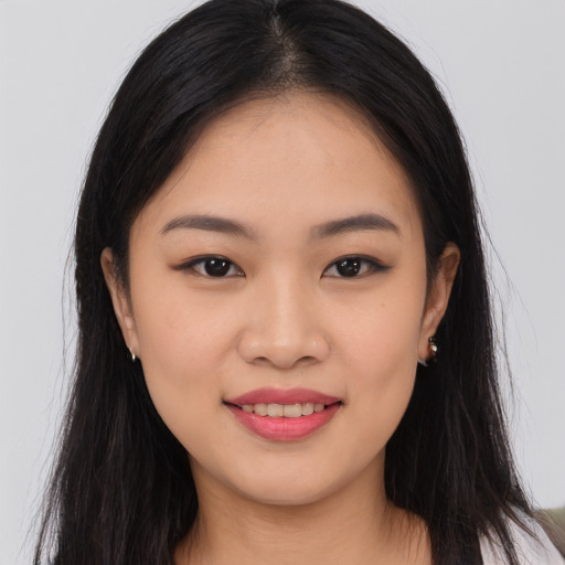 Joyful asian young-adult female with long  brown hair and brown eyes