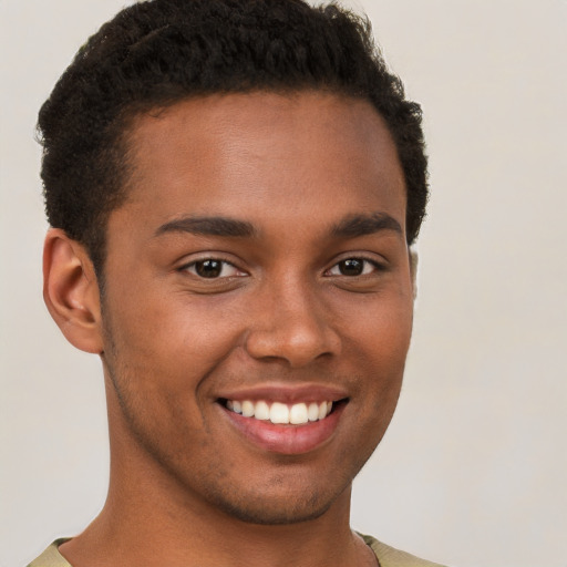 Joyful black young-adult male with short  brown hair and brown eyes