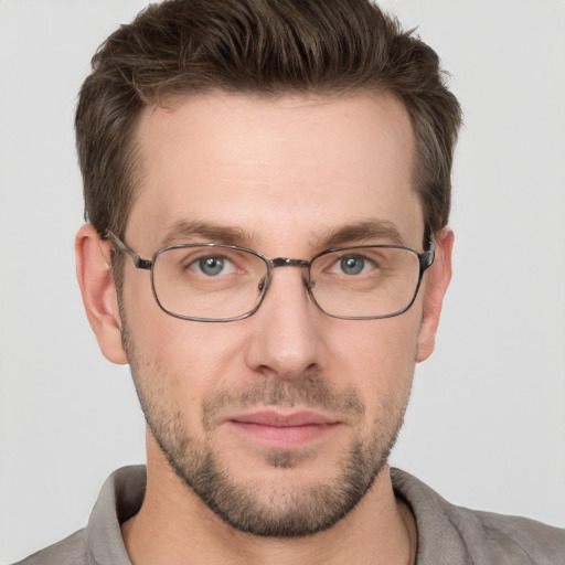 Joyful white young-adult male with short  brown hair and grey eyes