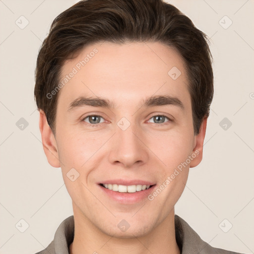 Joyful white young-adult male with short  brown hair and grey eyes