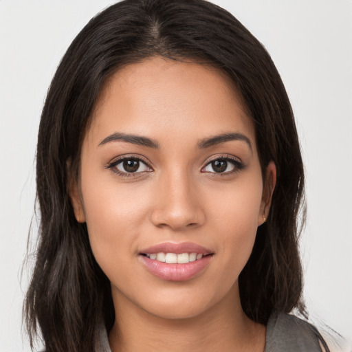 Joyful white young-adult female with long  brown hair and brown eyes