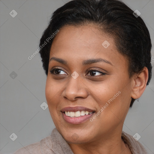 Joyful black young-adult female with short  brown hair and brown eyes